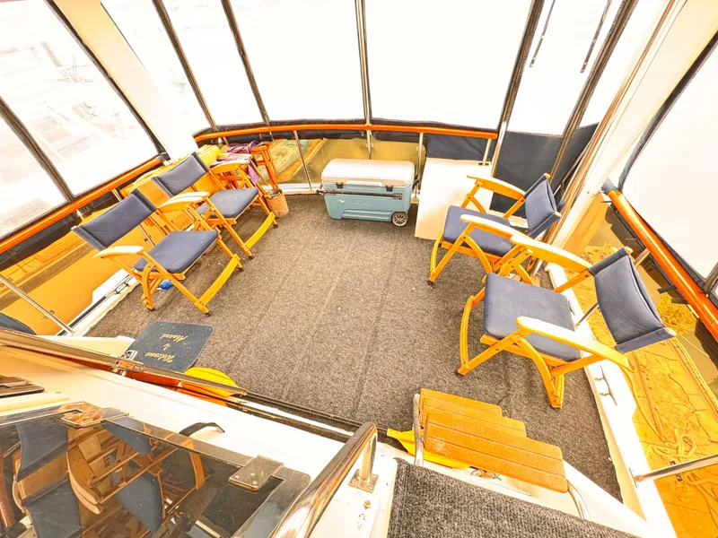 Slide: The Image of 1985 Symbol 51 Cockpit Motor Yacht interior with chairs and cooler. - 24
