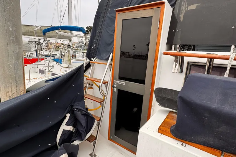 Slide: The Image of 1985 Symbol 51 Cockpit Motor Yacht with covered deck and sleek glass door in marina. - 25