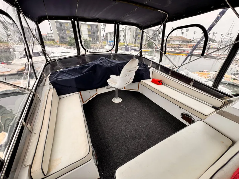 Slide: The Image of 1985 Symbol 51 Cockpit Motor Yacht interior with seating and helm chair. - 26