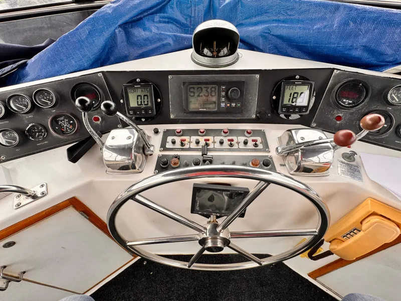 Slide: The Image of Cockpit of 1985 Symbol 51 Motor Yacht with steering wheel and control panel. - 27
