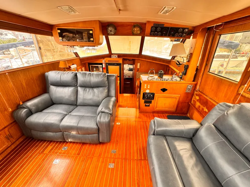 Slide: The Image of 1985 Symbol 51 Cockpit Motor Yacht interior with leather seating and wooden flooring. - 3