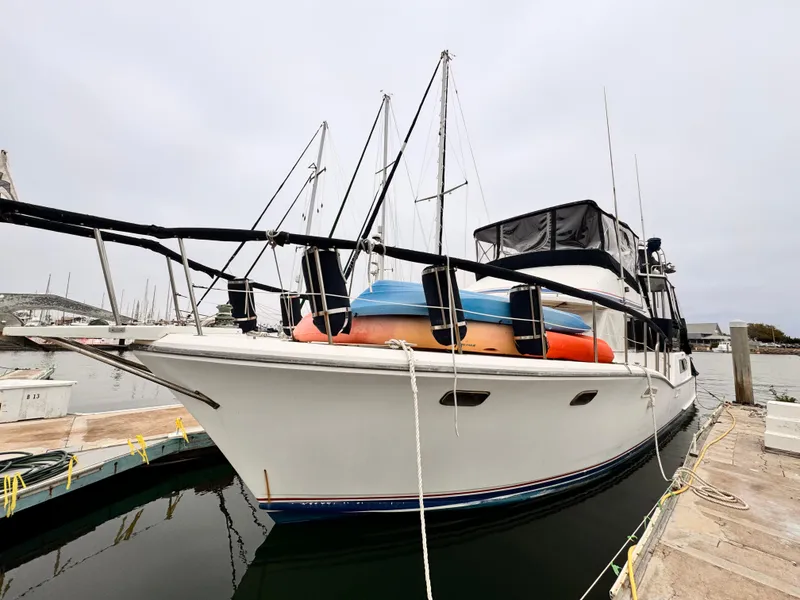 Slide: The Image of 1985 Symbol 51 Cockpit Motor Yacht docked at marina, featuring sleek design and spacious deck. - 31