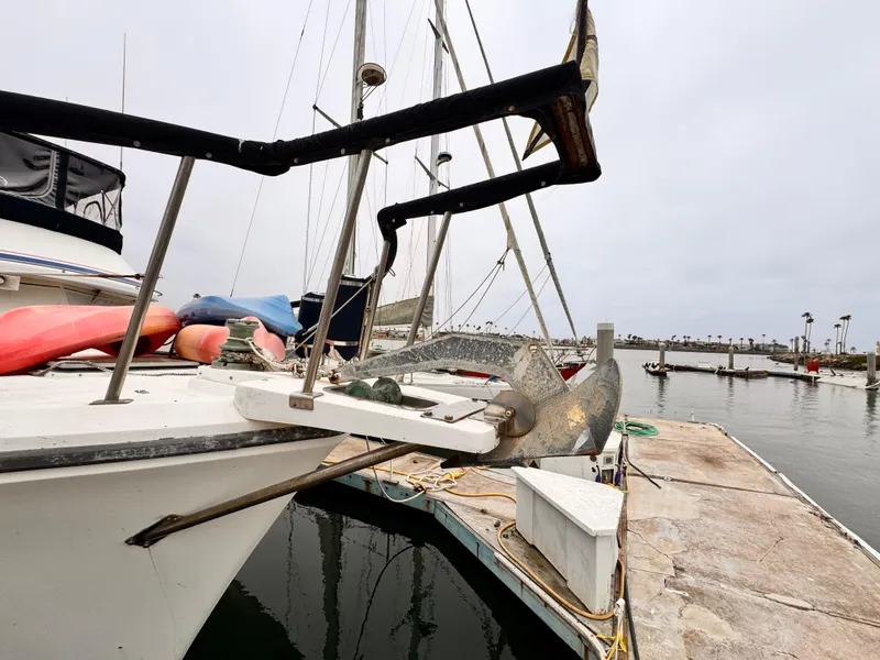 Slide: The Image of 1985 Symbol 51 Cockpit Motor Yacht docked at marina, featuring anchor and deck details. - 32