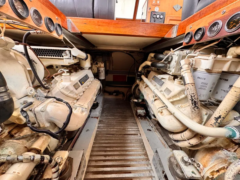 Slide: The Image of Engine room of 1985 Symbol 51 Cockpit Motor Yacht, showcasing dual engines and control panel. - 33