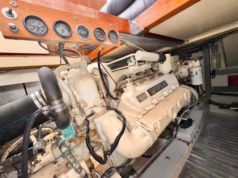 Slide: The Image of Engine room of a 1985 Symbol 51 Cockpit Motor Yacht, showcasing machinery and gauges. - 35