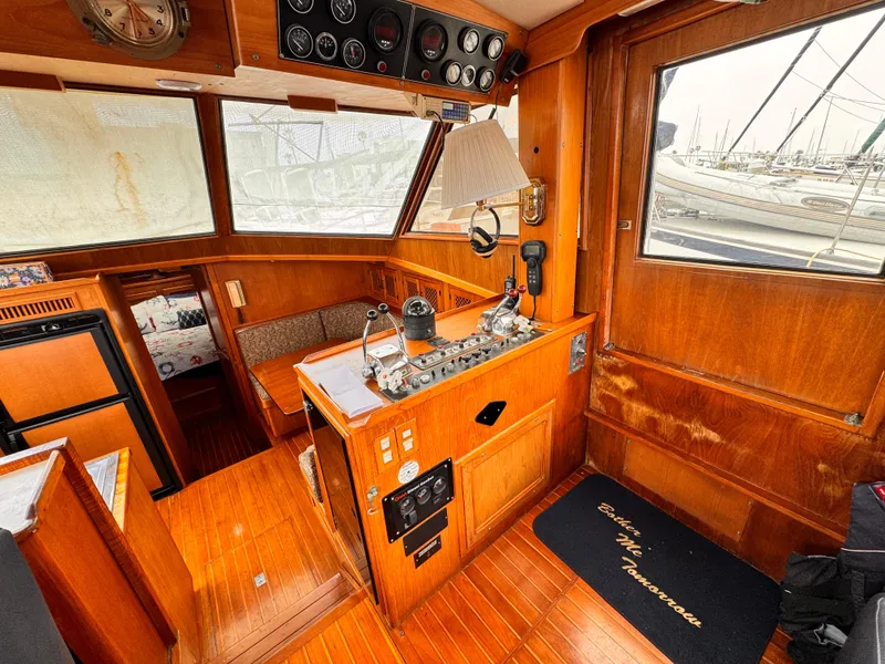 Slide: The Image of 1985 Symbol 51 Cockpit Motor Yacht interior with wooden finish and control panel. - 4