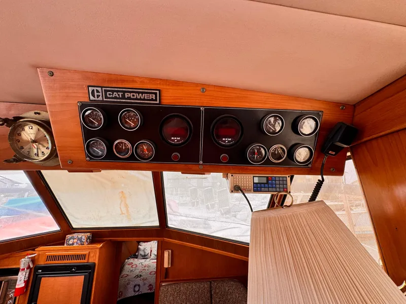 Slide: The Image of 1985 Symbol 51 Cockpit Motor Yacht dashboard with gauges and Cat Power panel. - 5