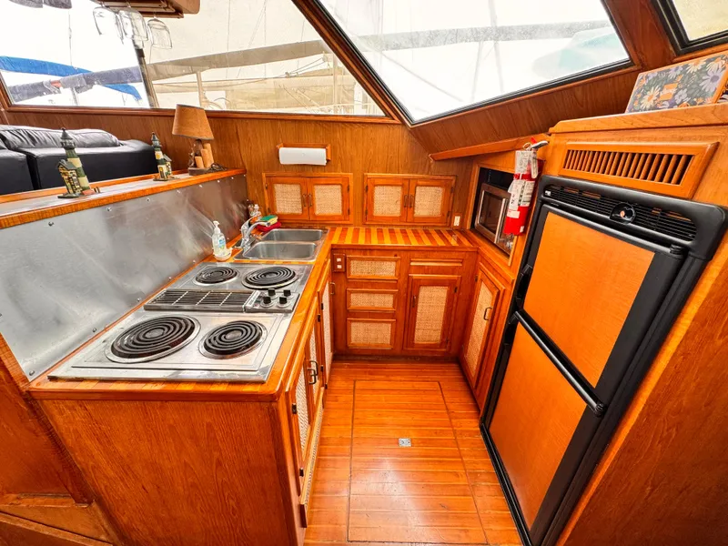 Slide: The Image of 1985 Symbol 51 Cockpit Motor Yacht kitchen with stove, sink, and refrigerator. - 8