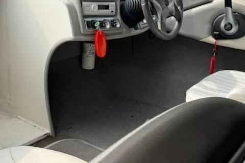 Slide: The Image of 2010 Bayliner 185S Bow Rider interior with steering wheel and dashboard controls. - 10