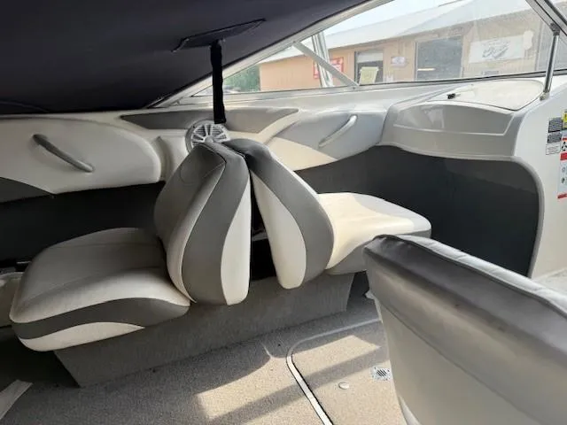Slide: The Image of Interior of 2010 Bayliner 185S Bow Rider boat with gray and white seating. - 12