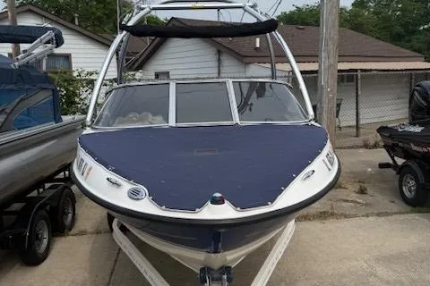Slide: The Image of 2010 Bayliner 185S Bow Rider on trailer, covered, parked outdoors. - 4