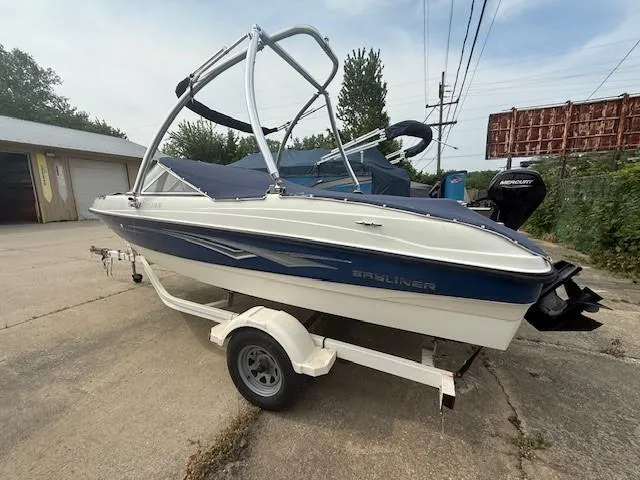 Slide: The Image of 2010 Bayliner 185S Bow Rider boat on trailer, parked outdoors. - 5