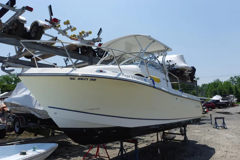 The Image of 2004 Polar 2300 Walkaround boat on dry dock, ready for maintenance. - 0