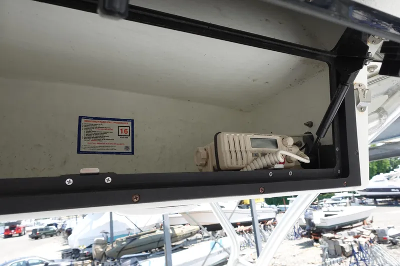 Slide: The Image of 2004 Polar 2300 Walkaround boat storage compartment with radio equipment. - 10
