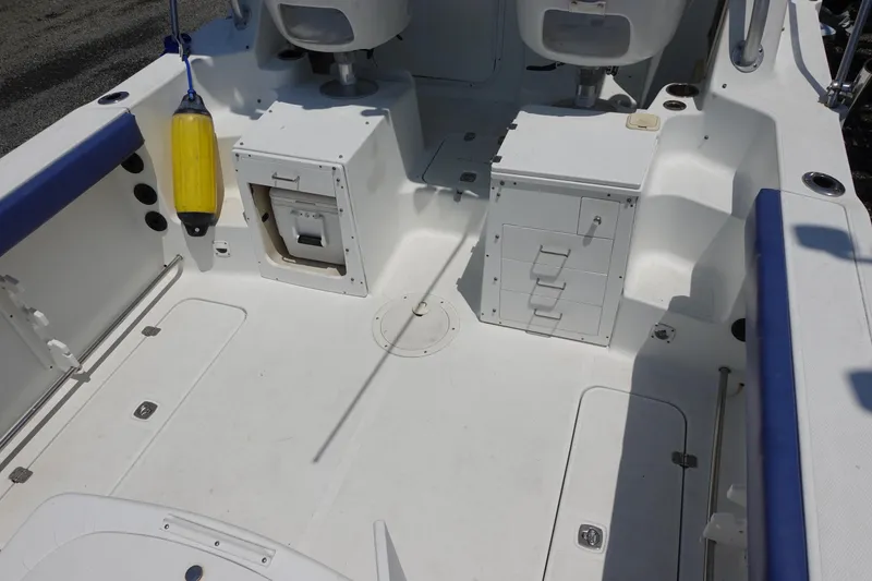 Slide: The Image of 2004 Polar 2300 Walkaround boat interior with storage compartments and seating. - 11