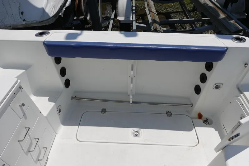 Slide: The Image of 2004 Polar 2300 Walkaround boat interior with storage compartments and seating. - 13
