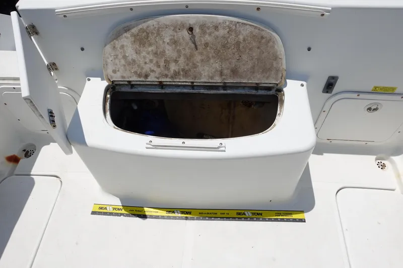 Slide: The Image of 2004 Polar 2300 Walkaround boat storage compartment with open lid, showing interior space. - 14