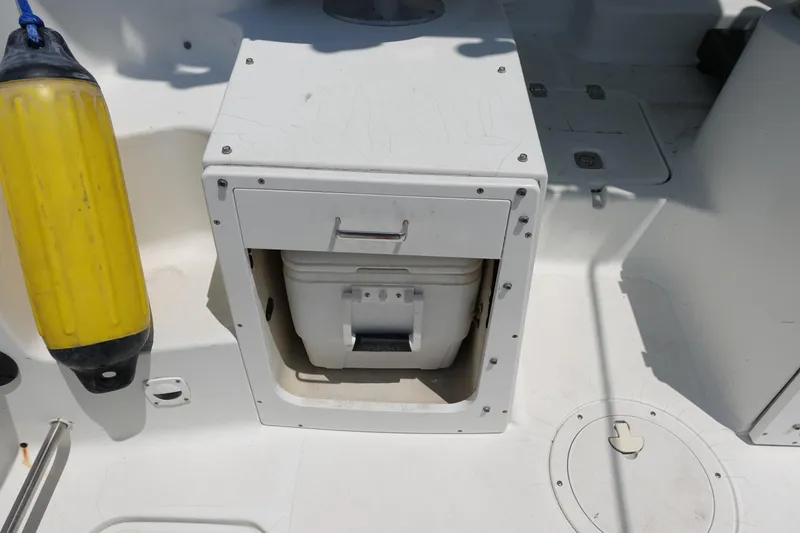 Slide: The Image of 2004 Polar 2300 Walkaround boat interior with storage compartment and yellow buoy. - 15