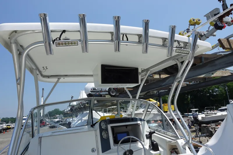Slide: The Image of 2004 Polar 2300 Walkaround boat with T-top and fishing rod holders. - 4