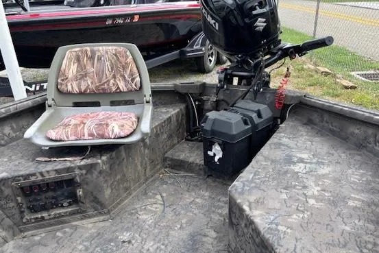 Slide: The Image of 2022 SeaArk 1648 Slayer boat interior with camo seat and Suzuki outboard motor. - 4