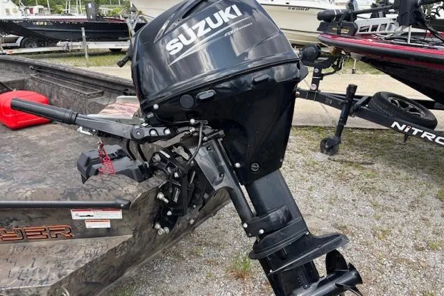 Slide: The Image of 2022 SeaArk 1648 Slayer boat with Suzuki outboard motor, parked on gravel. - 5
