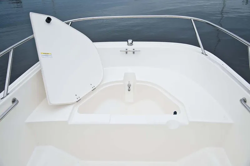 Slide: The Image of 2018 Boston Whaler 150 Super Sport boat interior with open storage compartment. - 33
