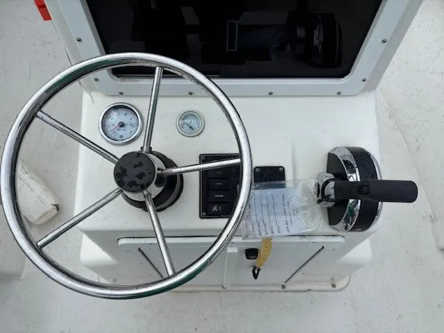 Slide: The Image of Steering console of 2021 May-Craft 1800 Skiff with gauges and throttle controls. - 15