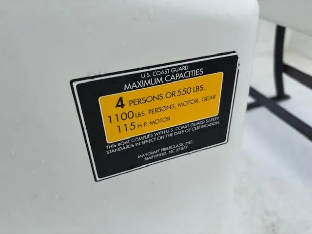 Slide: The Image of U.S. Coast Guard capacity label on 2021 May-Craft 1800 Skiff, detailing weight and passenger limits. - 18