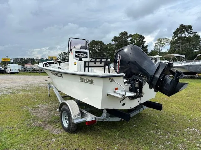 Slide: The Image of 2021 May-Craft 1800 Skiff on trailer with outboard motor, parked outdoors. - 4