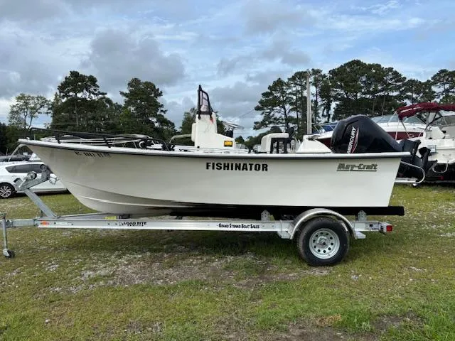 Slide: The Image of 2021 May-Craft 1800 Skiff boat named "Fishinator" on trailer, parked outdoors. - 7