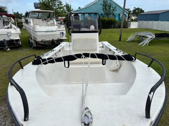 Slide: The Image of 2021 May-Craft 1800 Skiff boat in a yard, surrounded by other boats. - 8