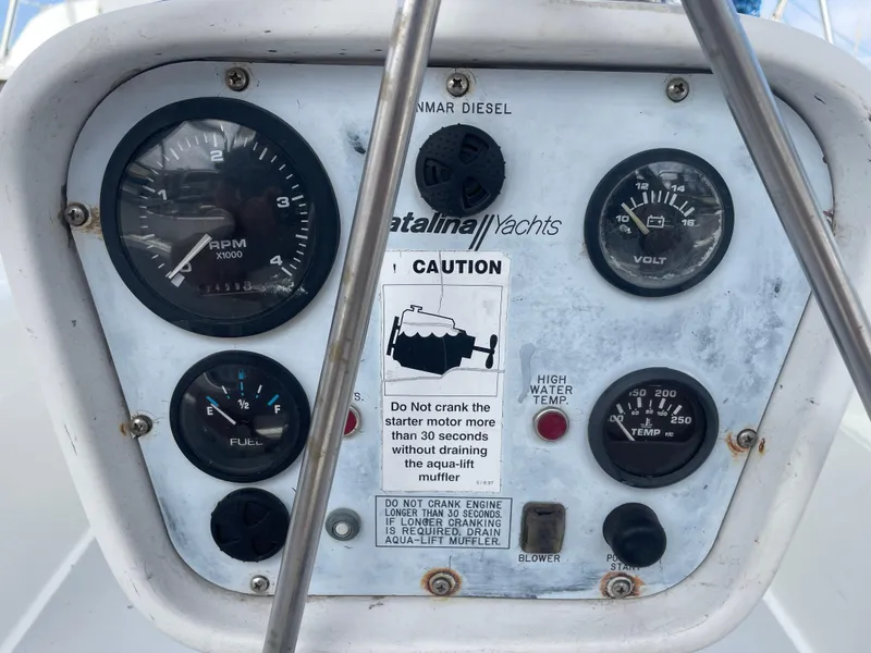 Slide: The Image of Control panel of a 1999 Catalina 42 MkII sailboat with gauges and caution label. - 14