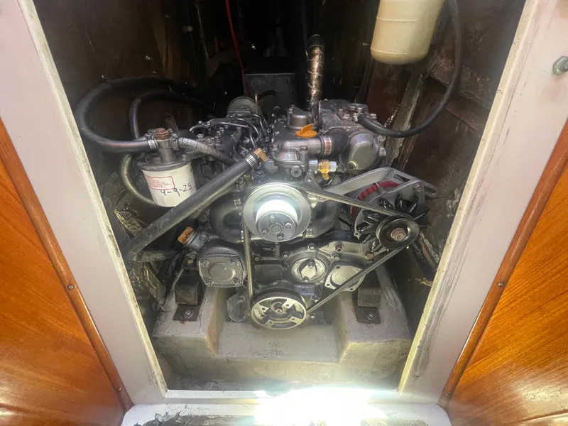 Slide: The Image of Engine compartment of a 1999 Catalina 42 MkII sailboat, showcasing mechanical components. - 15