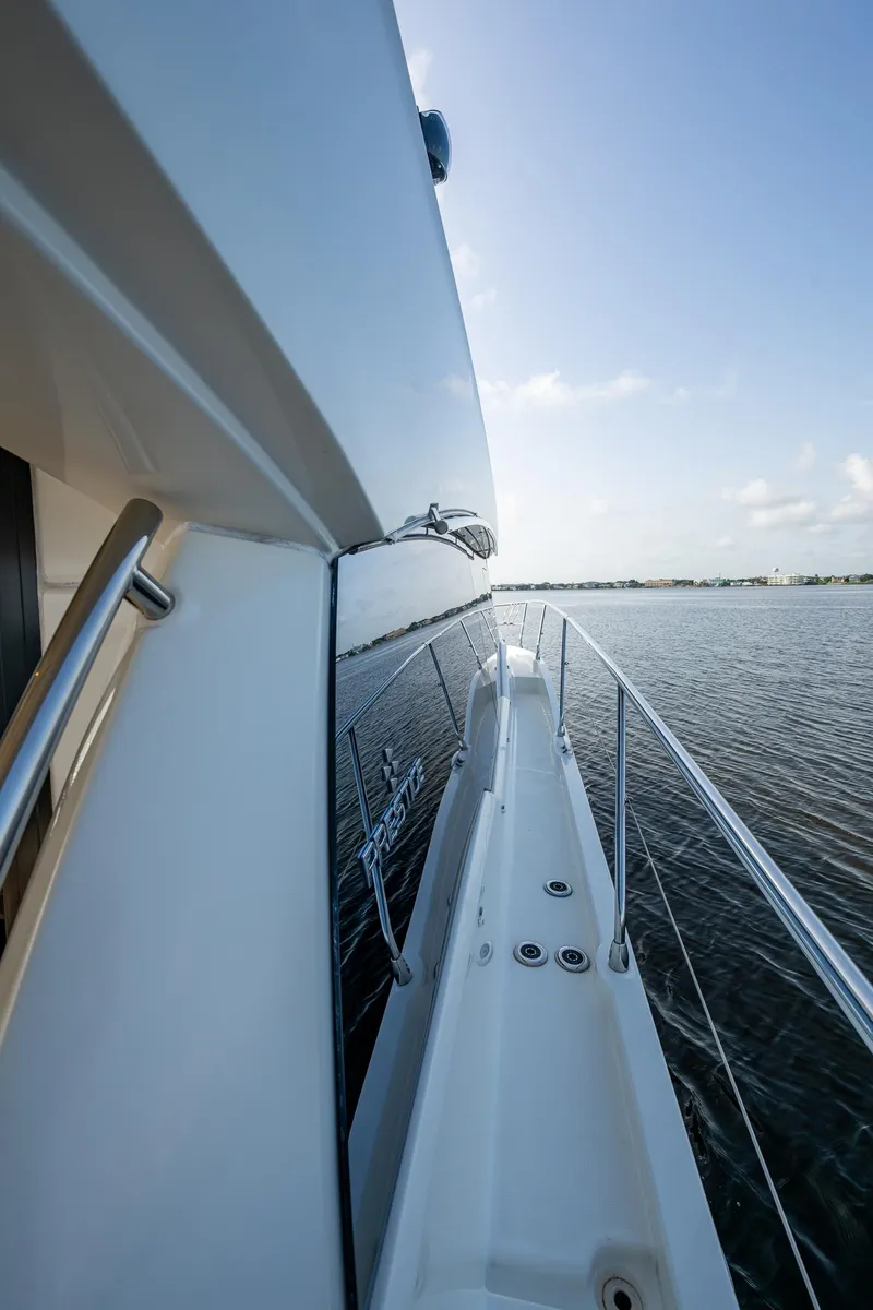 Slide: The Image of Side view of a 2019 Prestige 460 yacht on calm water. - 15