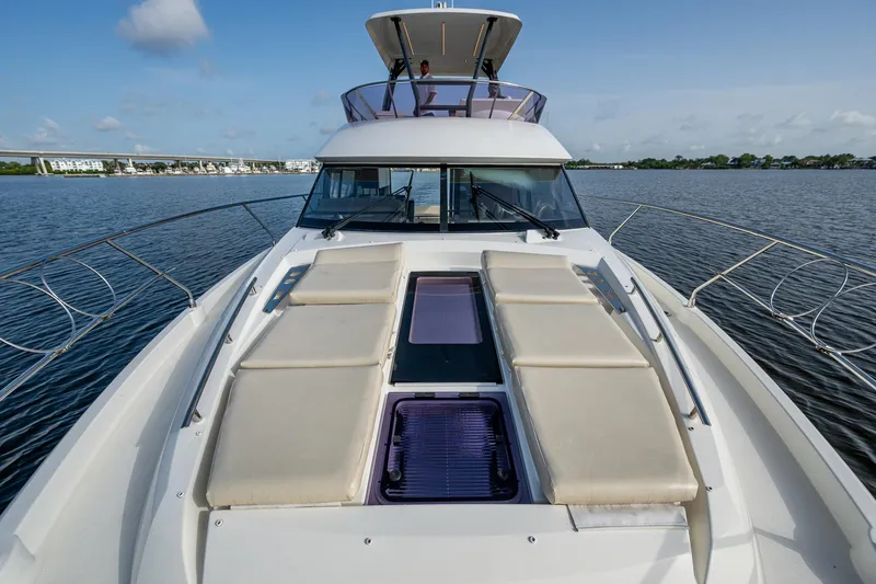 Slide: The Image of 2019 Prestige 460 yacht with sunbathing deck on calm water. - 17
