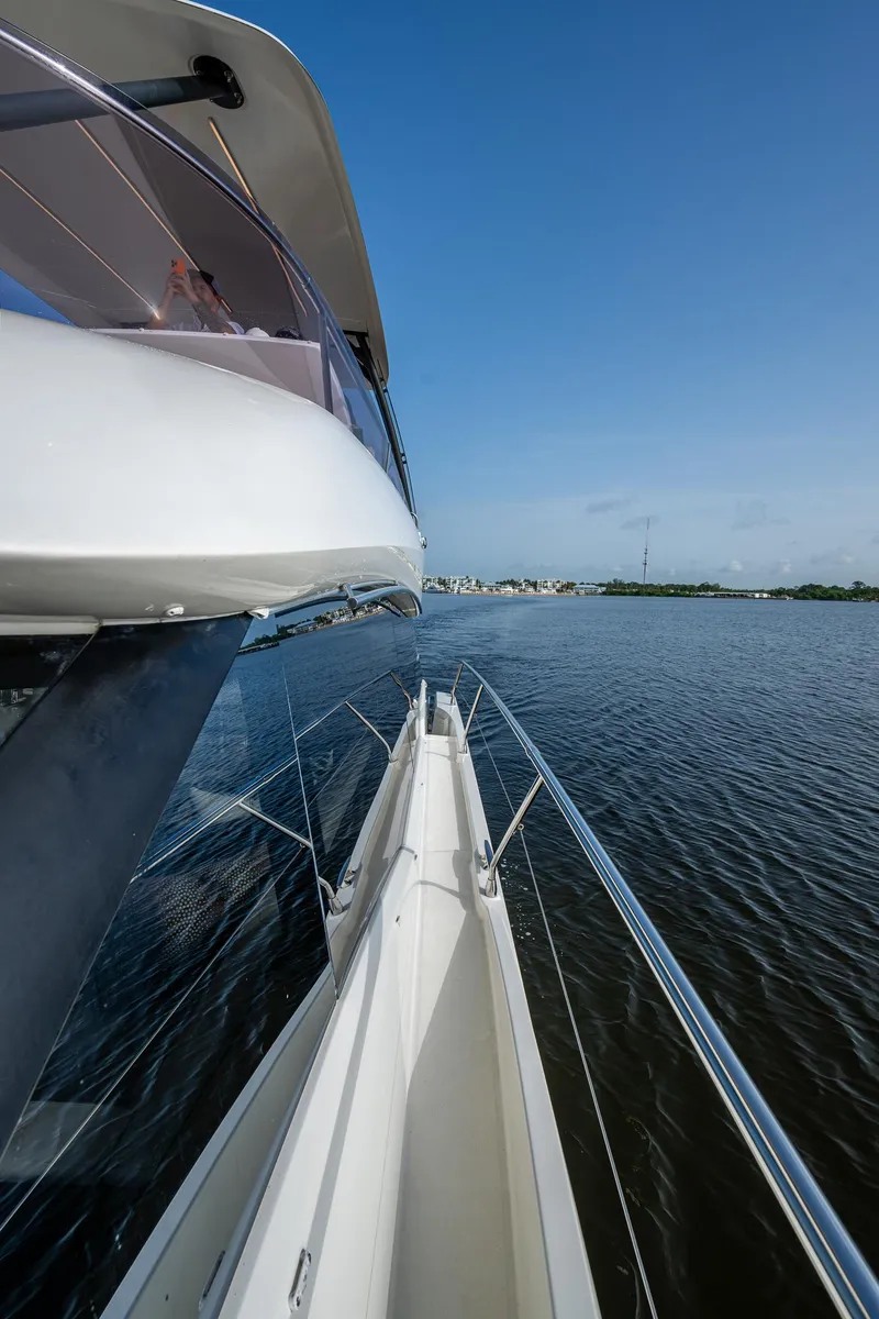 Slide: The Image of Prestige 460 yacht, 2019 model, cruising on calm waters under a clear blue sky. - 19