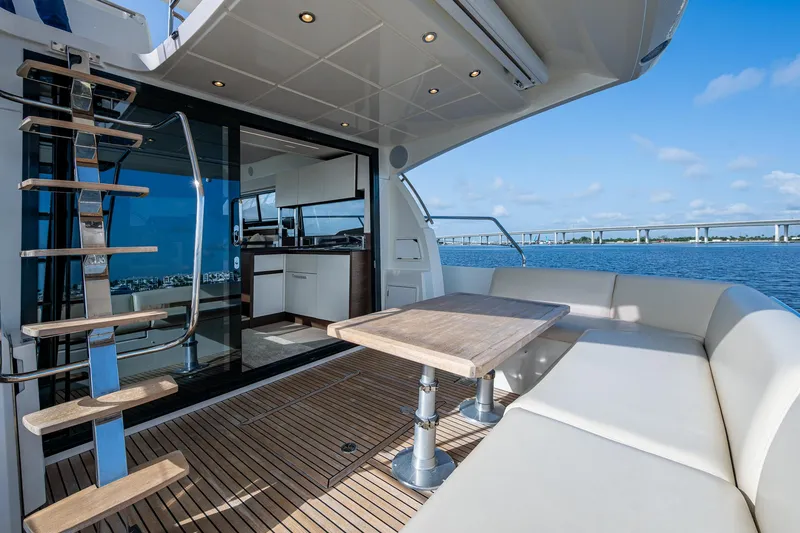 Slide: The Image of Luxurious 2019 Prestige 460 yacht deck with seating, table, and ocean view. - 21