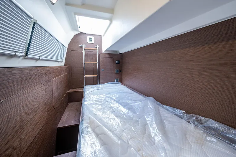 Slide: The Image of 2019 Prestige 460 yacht interior cabin with wooden walls and a skylight. - 27