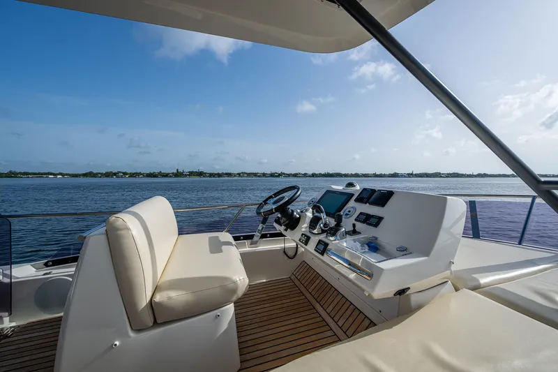 Slide: The Image of Luxurious 2019 Prestige 460 yacht helm with scenic water view. - 35