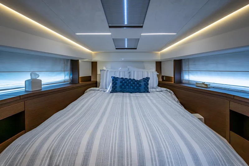 Slide: The Image of Luxurious bedroom interior of a 2019 Prestige 460 yacht with modern lighting and decor. - 39