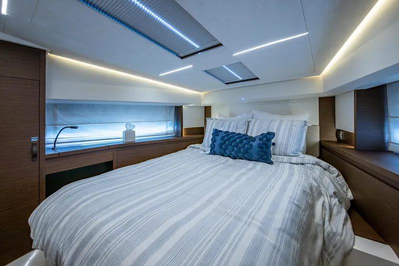 Slide: The Image of Luxurious bedroom interior of 2019 Prestige 460 yacht with modern lighting and cozy bedding. - 40