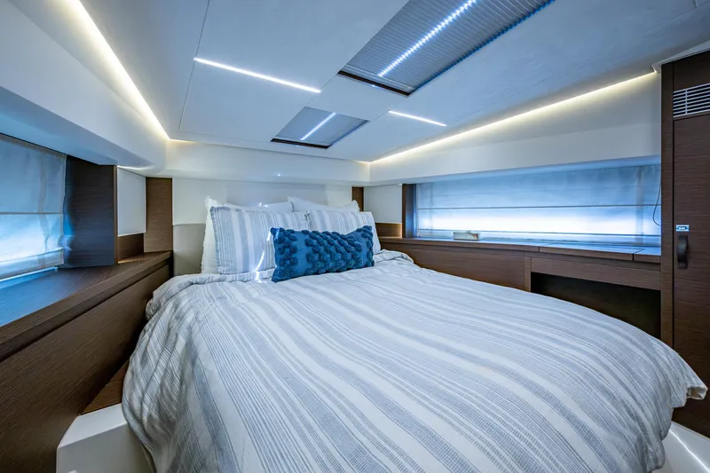 Slide: The Image of Luxurious bedroom interior of 2019 Prestige 460 yacht with modern lighting and cozy bedding. - 43