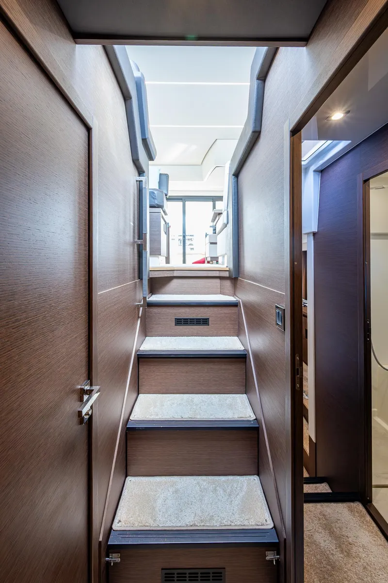 Slide: The Image of Interior staircase of 2019 Prestige 460 yacht, featuring modern design and wood finish. - 49