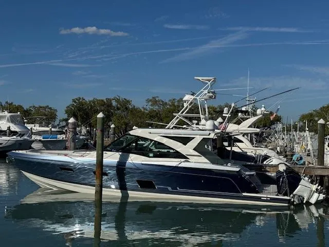 The Image of 2022 Formula 430 Super Sport Crossover yacht docked in a marina under clear blue skies. - 0