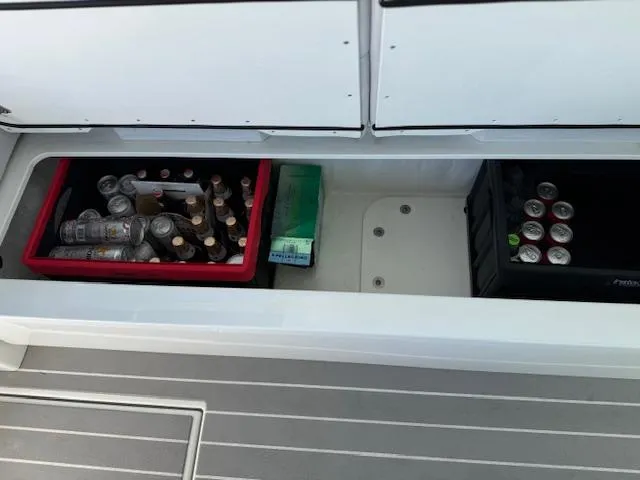 Slide: The Image of Storage compartment on 2022 Formula 430 Super Sport Crossover with drinks and supplies. - 10