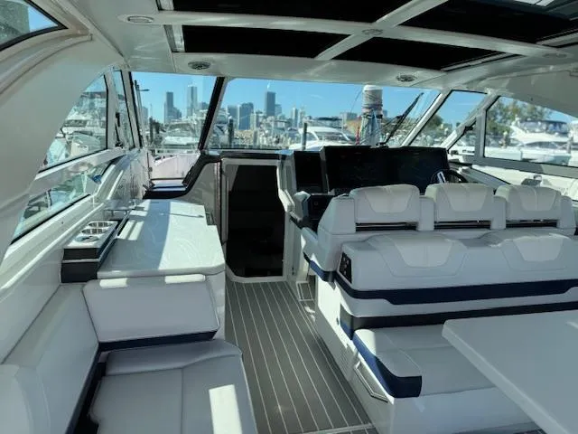Slide: The Image of Interior of 2022 Formula 430 Super Sport Crossover yacht with luxurious seating and city skyline view. - 12