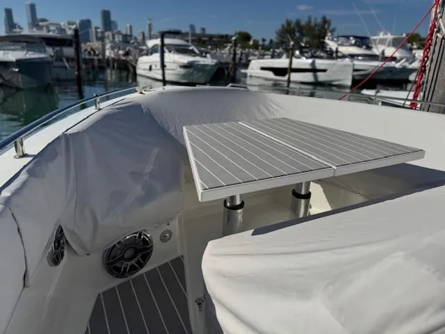 Slide: The Image of 2022 Formula 430 Super Sport Crossover yacht interior with table, docked at marina. - 19