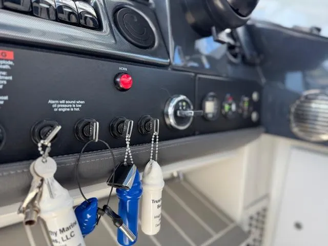 Slide: The Image of Control panel of 2022 Formula 430 Super Sport Crossover with keys and switches. - 23