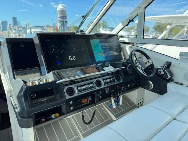 Slide: The Image of 2022 Formula 430 Super Sport Crossover cockpit with advanced navigation displays and controls. - 25