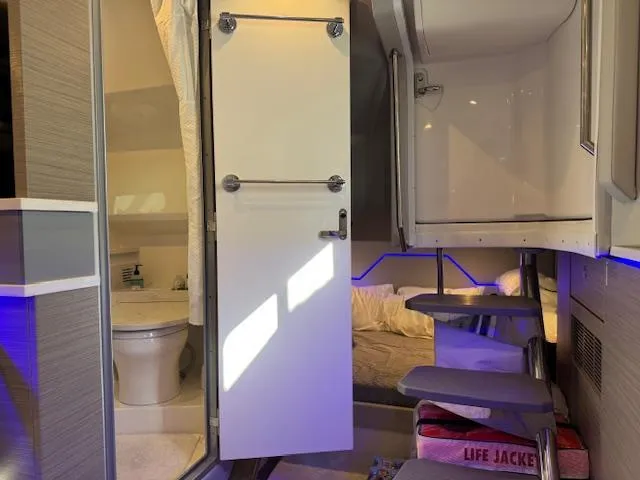 Slide: The Image of 2022 Formula 430 Super Sport Crossover interior with bathroom, bed, and life jackets. - 36